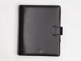 the black leather ipad case is open on a white surface