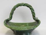 an image of a green bowl with a handle on a white background