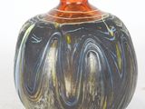 a vase that is sitting on a white surface