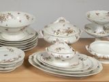 a lot of plates and bowls on a wooden table