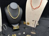 many different types of jewelry on display on a table