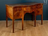a small wooden table with two drawers on it