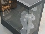 a glass case with a computer inside of it on the floor