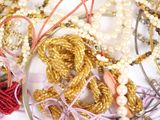 a lot of beads and bracelets on a table