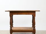 an old wooden table with a shelf on top of it