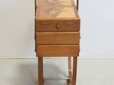 a small wooden table with a drawer on top of it