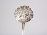 a silver spoon sitting on top of a table