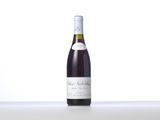 a bottle of wine sitting on top of a white table