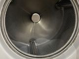 a close up of a washing machine with the door open