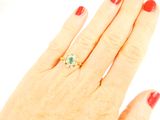 an image of a woman ' s hand with a ring on it