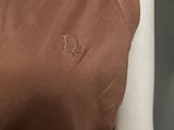 a mannequin wearing a brown top with the letter b on it