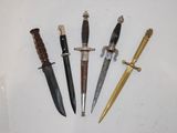 four different types of knives are displayed on a white surface