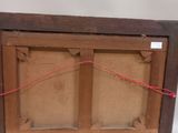 an old picture frame with a red string hanging from it