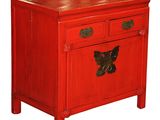 a small red cabinet with a butterfly on it