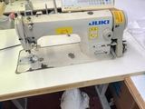 a sewing machine that is sitting on a table in a room