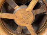 a rusted wheel on the side of a fire hydrant