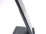 a cell phone on a stand on a white surface