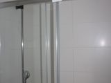 a shower with a glass door in a bathroom