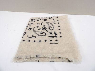 bandana with a black and white design on it sitting on a white surface