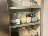 many containers of milk on the shelves in the kitchen
