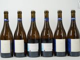 six bottles of wine are lined up in a row on a table