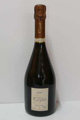 an old bottle of champagne sitting on a white surface
