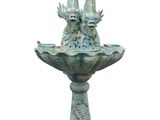 two birds sitting on top of a birdbath