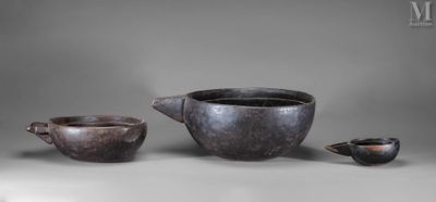 two cups and a teapot sit on a table next to each other