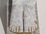 a marble sculpture of a foot on a stand