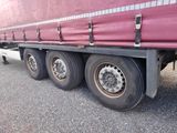 a red semi truck that is parked on the side of the road