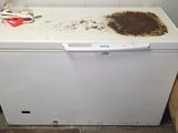 a dirty dishwasher sitting in a dirty kitchen