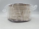 a spool of yarn wrapped in plastic on a table