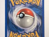 a close up of a pokemon card on a white surface