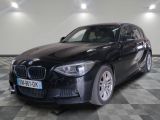 a picture of a black bmw car parked in a showroom
