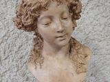 a bust of a woman with curly hair on a table
