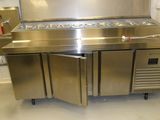 a large stainless steel kitchen with a refrigerator and freezer