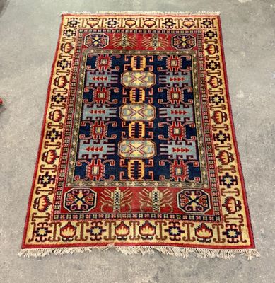 rug on the floor with a red, blue, and yellow design