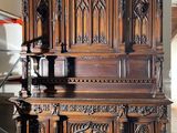 a large wooden cabinet in the middle of a room