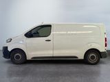 the white van is parked on the concrete floor in the room