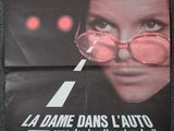 an old movie poster with a woman wearing glasses on the side of the road