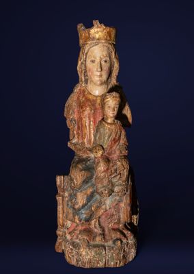 a wooden statue of a woman holding a child in her lap