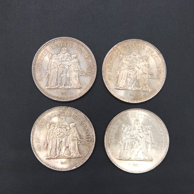 three silver coins with a picture of a man and a woman on them