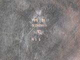a close up of a silver plate with a picture on it