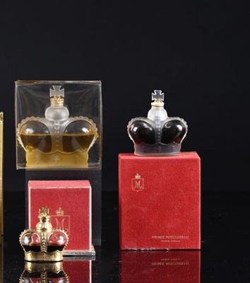 three bottles of perfume sitting on top of a table next to each other
