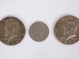 three quarters of the same type of coin are shown on a white surface