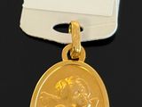 a close up of a gold medal on a black surface