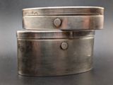 two metal containers that are stacked on top of each other