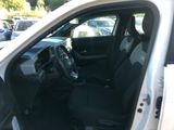 the interior of a car with the door open and the driver ' s seat down