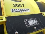a yellow machine that is sitting in the dirt