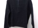 the sweater is black and has a zipper on the front